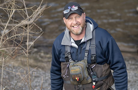 Douglas Mason next to a creek