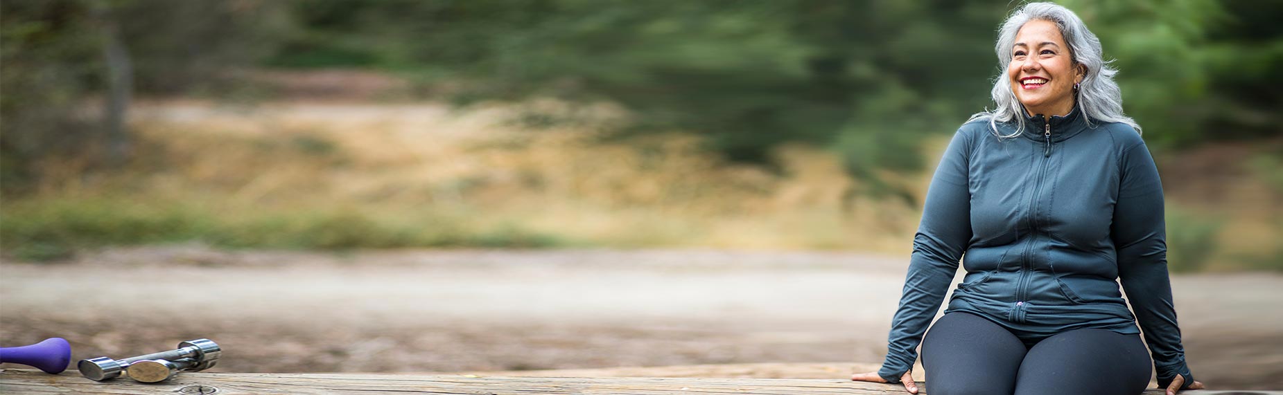 Woman wearing work out gear rests on a bench.