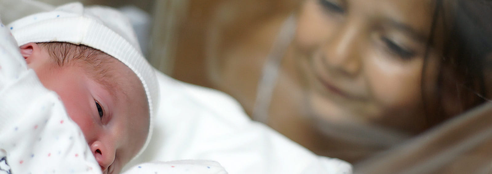 Little sister in NICU looking at infant sibling