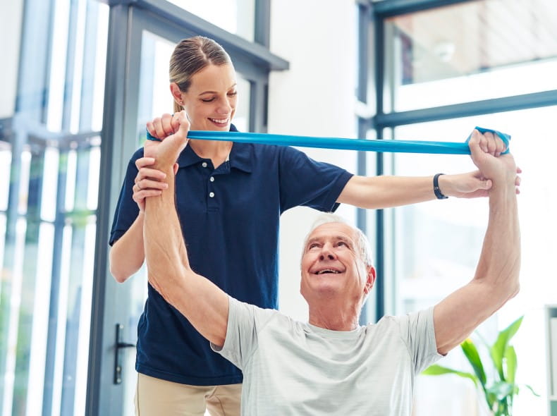 a physical therapist helping a patient stretch