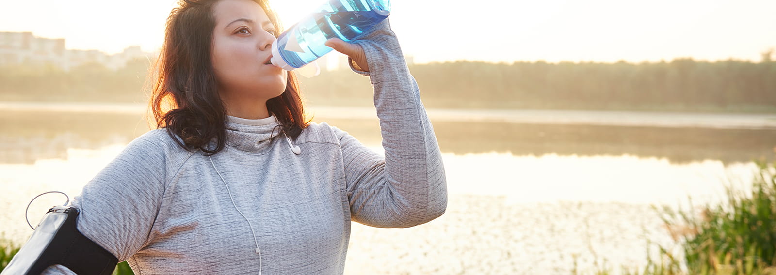 Active woman drinking water