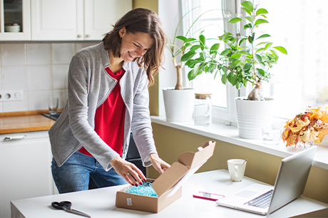 Young woman receiving a package at home.