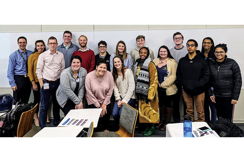 Dr. Thomas Davis (far left) and Dr. Robert Lowe, standing next to Dr. Alex Chop, crouching, left, with GCSOM’s med/peds interest group.