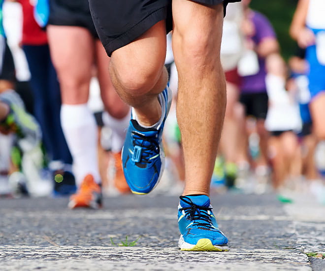 A closeup of runner's shoes during a long-distance road race.