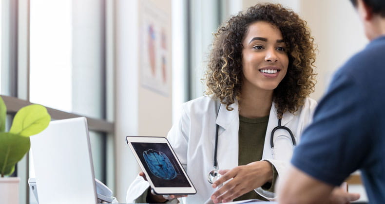 an image of a healthcare worker discussing x-ray scan with patient