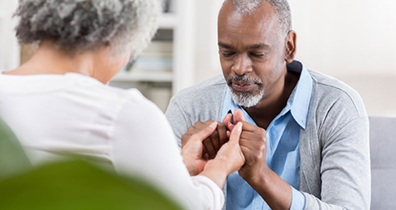 an image of an older couple praying