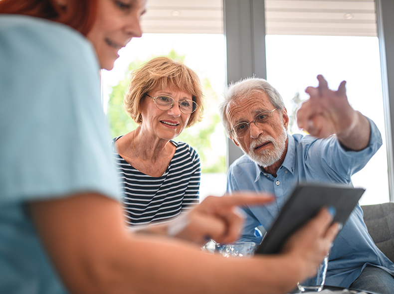 Senior man and woman speaking with doctor