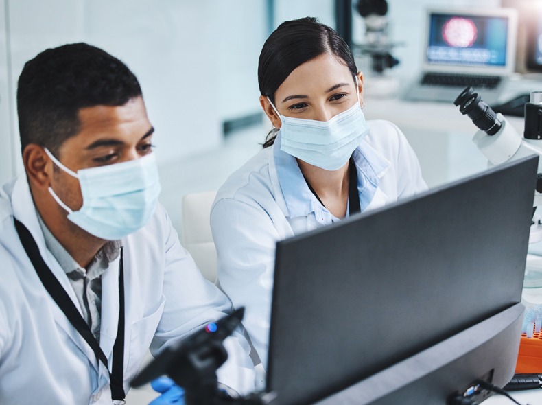 Two medical staff members looking at a monitor