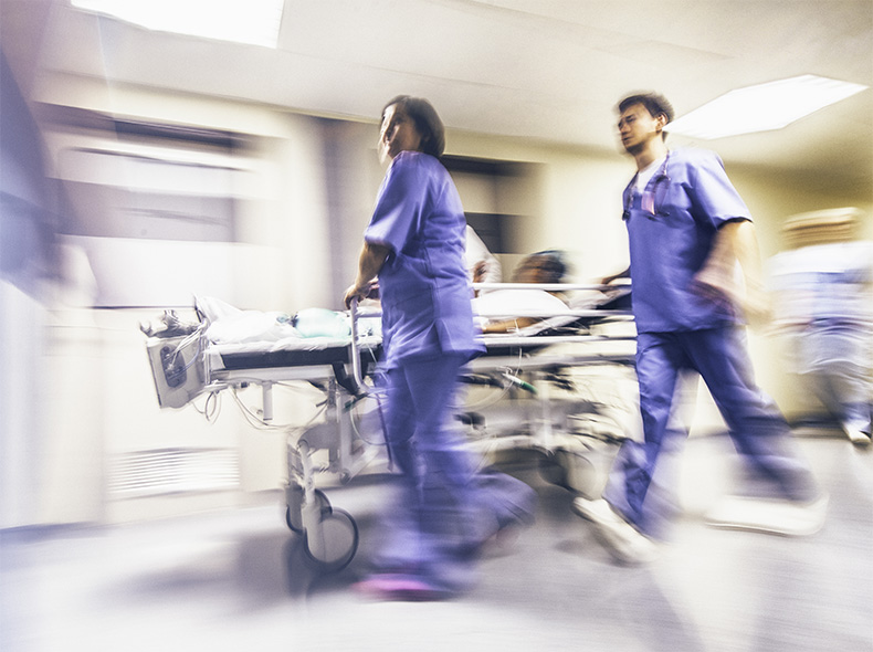 Hospital staff moving a patient