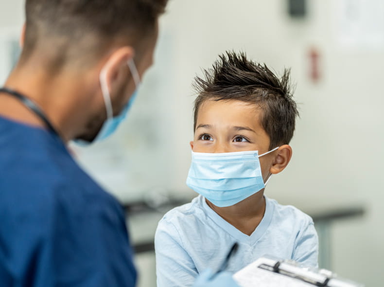 Male doctor with a child patient