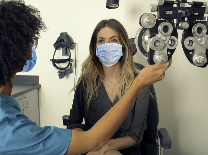 an ophthalmologist checking a patience eyes