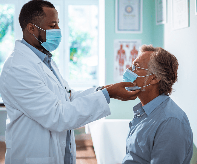 Masked doctor and patient at clinic