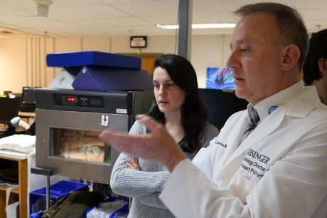 Everhart Museum Curator Francesca Saldan and Dr. Scott A. Sauerwine, medical director for Geisinger Radiology, discuss the images. 