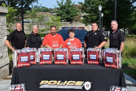 Geisinger Community Medical Center presents stop the bleed kits to University of Scranton police.