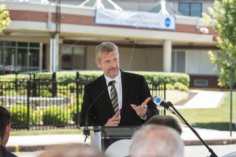 Speaker at podium of GSWB ribbon cutting.