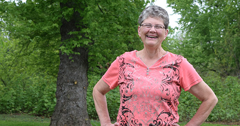 Woman standing outside by tree