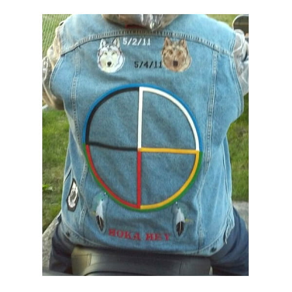 Transplant recipient wears motorcycle vest dedicated to donor