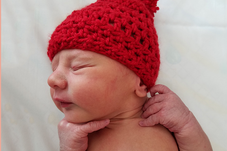 Baby in red knit hat - American Heart Association’s Little Hats, Big Hearts campaign