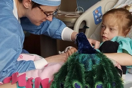 Patient Reagan Sheetz holding her peacock