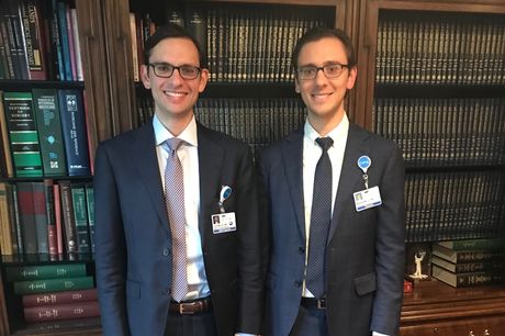 Dr. John Mercuri and Dr. Matthew Mercuri in a library.