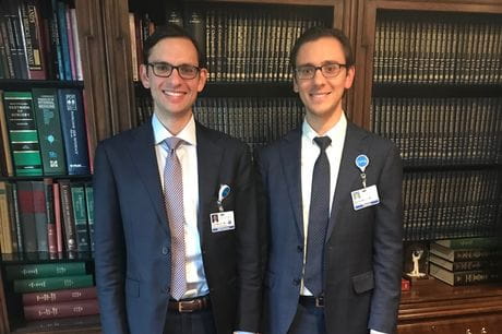 Dr. John Mercuri and Dr. Matthew Mercuri in a library.