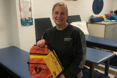 Geisinger certified athletic trainer Robin Jackson with his automated external defibrillator (AED).