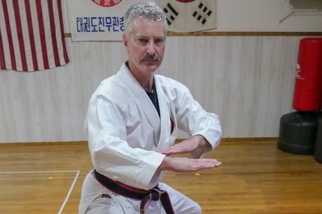 Doug practicing tae kwon do in his studio.