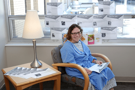 Katie Cowfer, a patient at Geisinger Medical Center, is surrounded by postcard notes from friends and family.