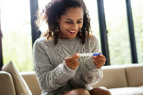 Woman looking at pregnancy test.