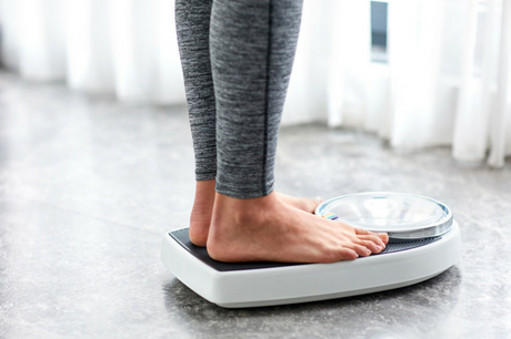 Woman standing on scale