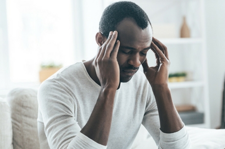 Man holding head with hands
