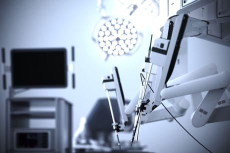 Close-up of robotic arms in an empty surgery room.