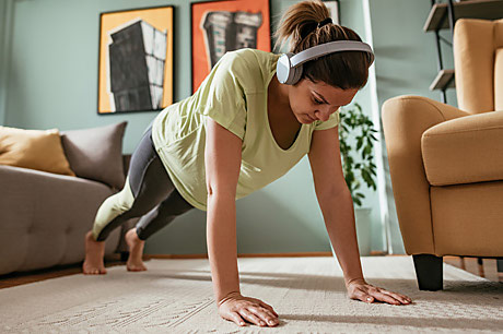 Young woman excercising at home.