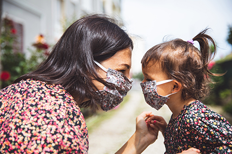 A mom & daughter wearing masks
