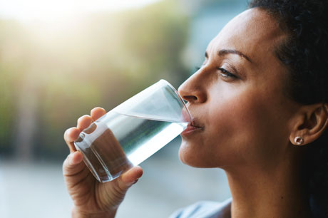 Woman drinking a glass of water.