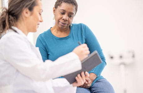 Doctor talking to woman patient. 