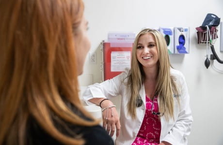 a female doctor talks to a female patient
