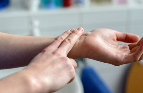 A person checking their pulse.