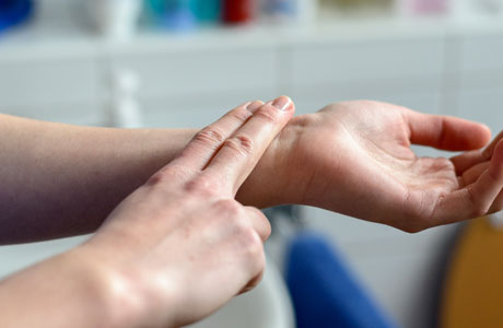 A person checking their pulse.