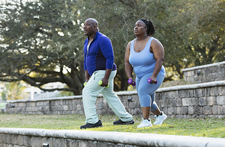 Man and woman doing lunges preparing for weight loss surgery.