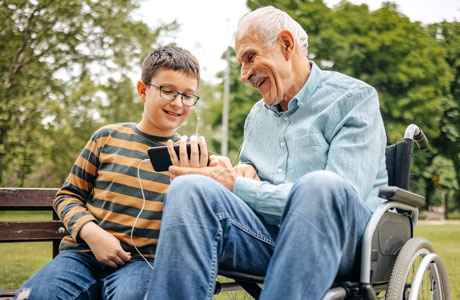 A child with his grandparent outside