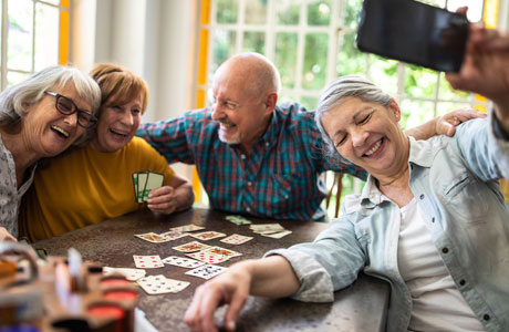 Seniors playing cards amidst the challenge of Alzheimers.
