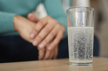 Close-up of a glass of water preparing for a colonoscopy