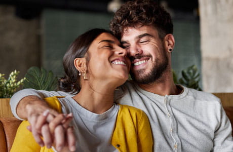 A couple holding hands and hugging.