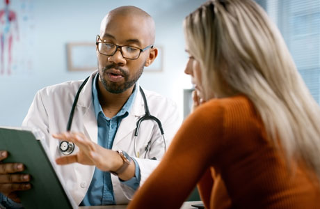 Doctor speaking with a woman patient. 