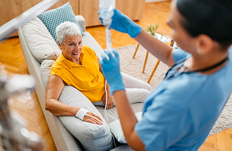 A woman at home receiving in home infusion therapy