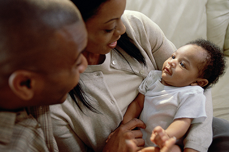 Couple looking down at their baby