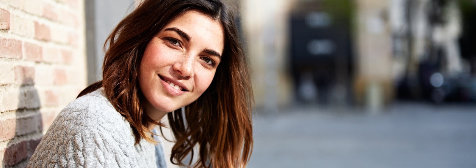 A smiling woman receiving trauma and PTSD support