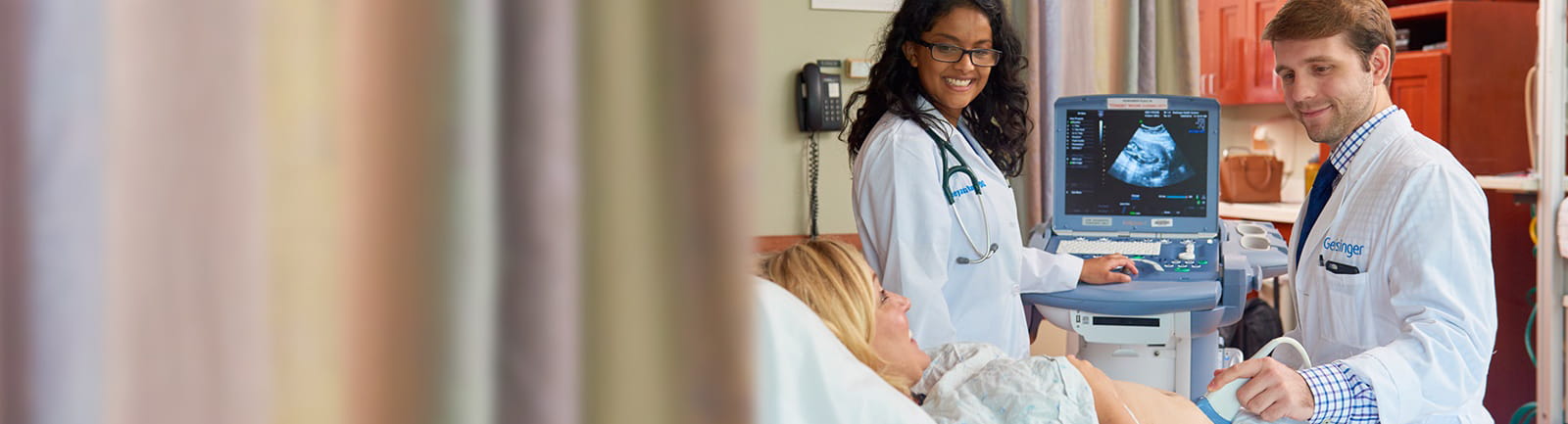 Two doctors performing ultrasound