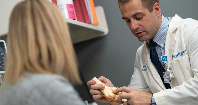 A doctor doing a demonstration for his patient